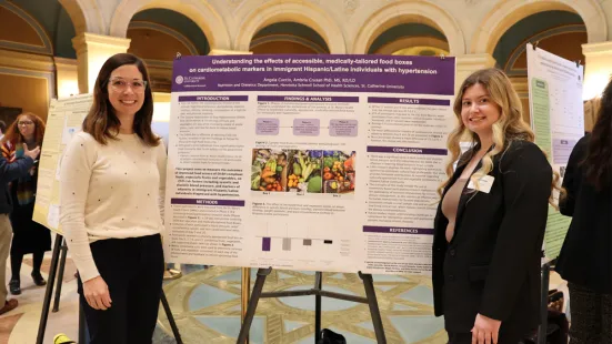 Students pose with their research posters