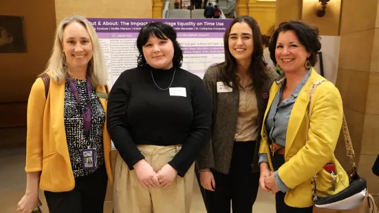 Students with their research poster at the Capitol