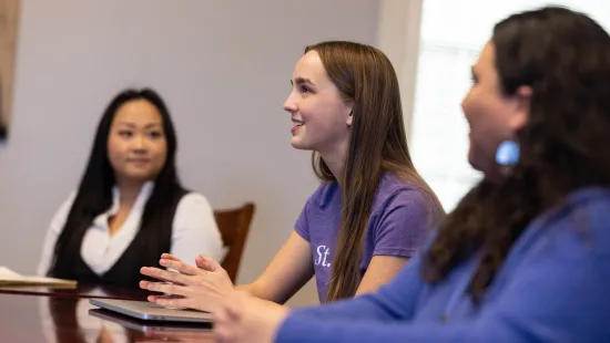 Students and counselors in discussion around a table