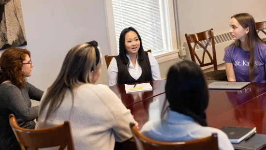 Students and counselors discussing around a table
