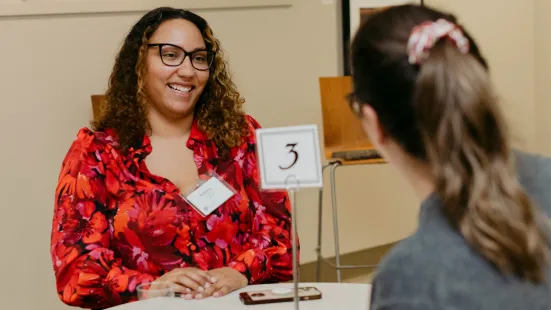 One panelist member talking with attendee 