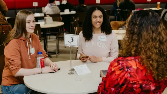 Two students with an alum