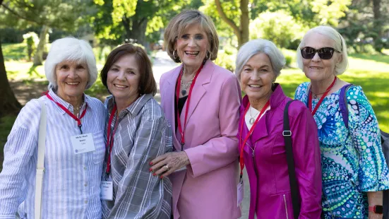Five women celebrating their Reunion pose outside.