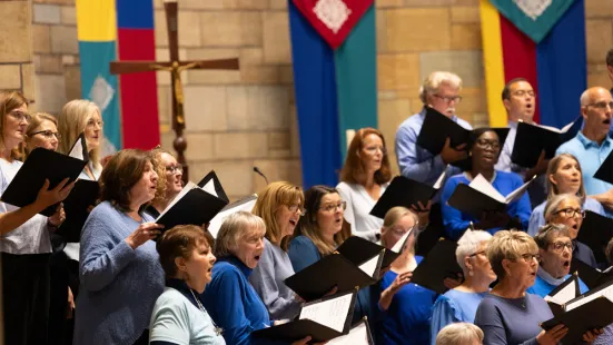 A choir, holding songbooks, sings during Mass.