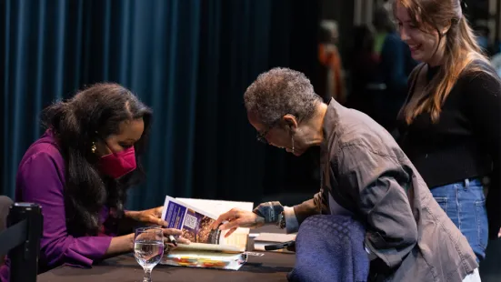 Isabel Wilkerson signs books for community members