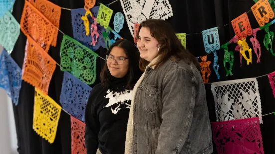 Students pose at the photobooth at Día de los Muertos 2024