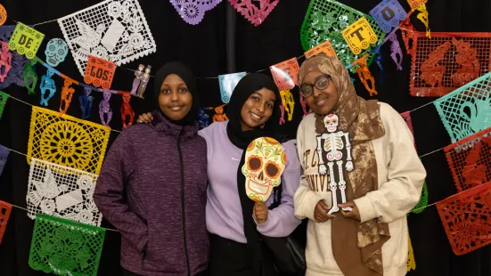 Students pose at the photobooth at Día de los Muertos 2024