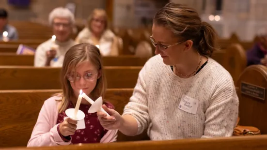 Hilary Novacek Bundt ’08 lights her daughter's candle.