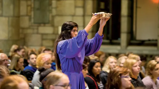 A student in purple raising a crown.
