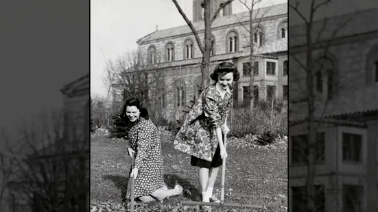 Two students raking leaves in the Chapel lawn.