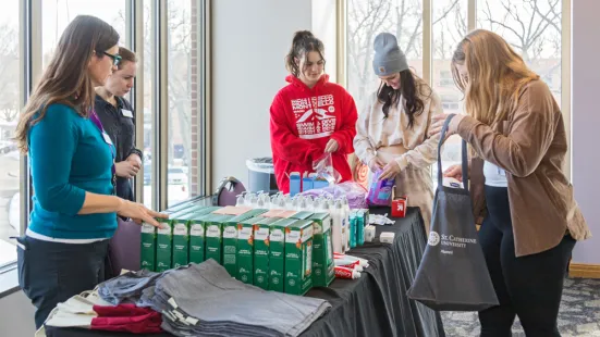 Students obtaining hygienic products at faculty tabling.