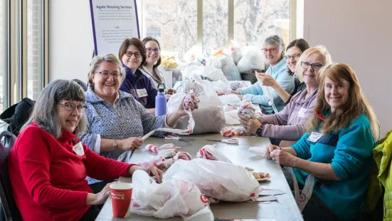 A group of smiling people sit around a table.