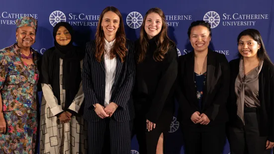 President Marcheta P. Evans, PhD, and Dame Jacinda Ardern pose with current St. Kate's students
