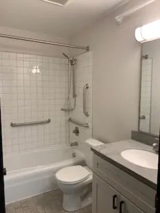 Apartment bathroom for Georgia and Alberta apartments. It is clean and white-tiled.