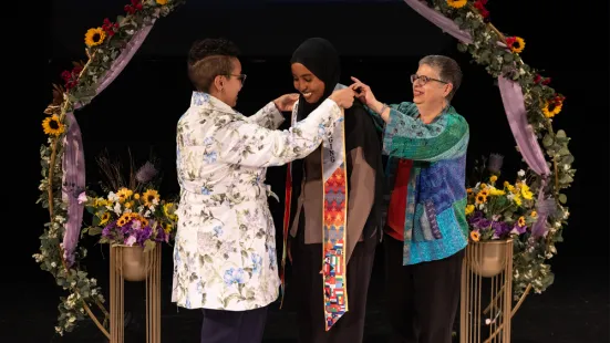 Noha Elmohands and Jacqueline N. Font-Guzmán bestow a CEB Faisa Mohamed ’25 sash on 
