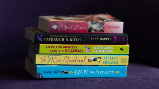 Five books stacked on top of each other. Top to bottom: Forbidden by Beverly Jenkins, Payback's a Witch by Lana Harper, An Island Princess Starts A Scandal by Adriana Herrera, The Kiss Quotient by Helen Hoang, and Recipe for Persuasion by Sonali Dev.