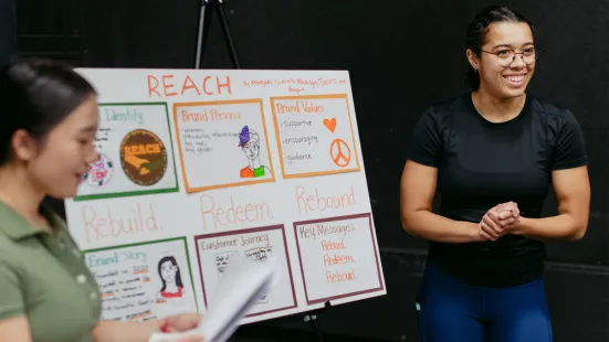 Two students presenting information on a poster.