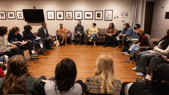 Ta-Nehisi Coates sits with a group of students in a circle of chairs. 