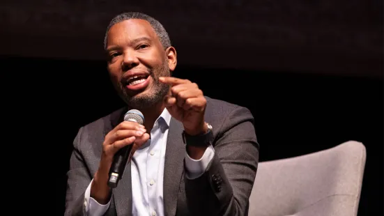 Ta-Nehisi Coates speaks into a microphone on stage.