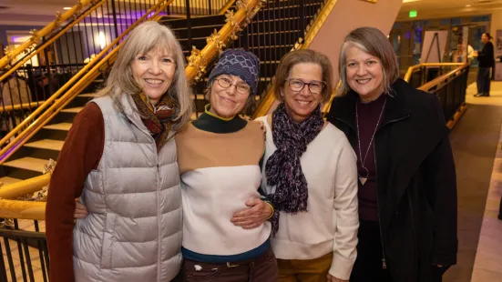 A group of women smile at the Feast of Saint Catherine reception.