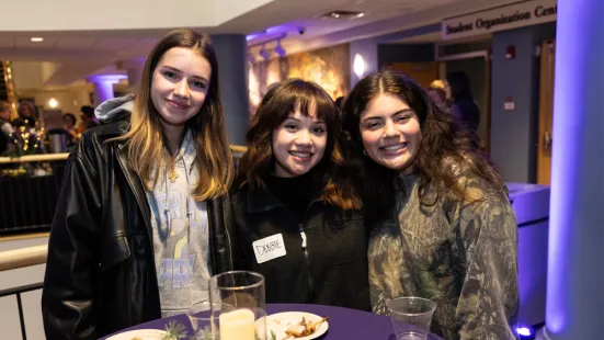 Students smile at the Feast of Saint Catherine reception.