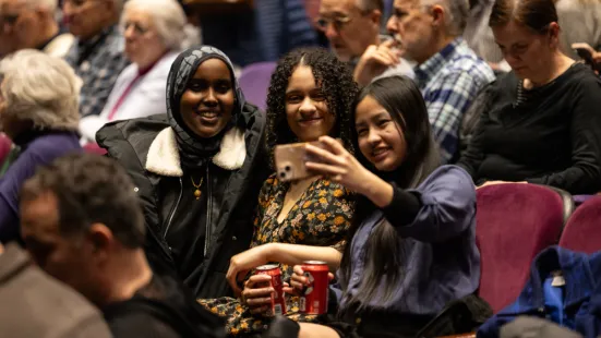 Three students take a selfie in The O'Shaughnessy audience