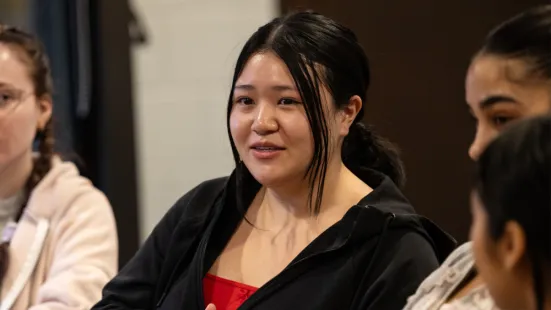 A student from the circle discussion listens. 