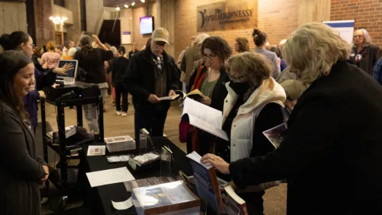 Attendees look at books in The O'Shaughnessy lobby after the event.