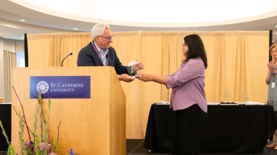 Dean Marc Manganaro presents award to recipient