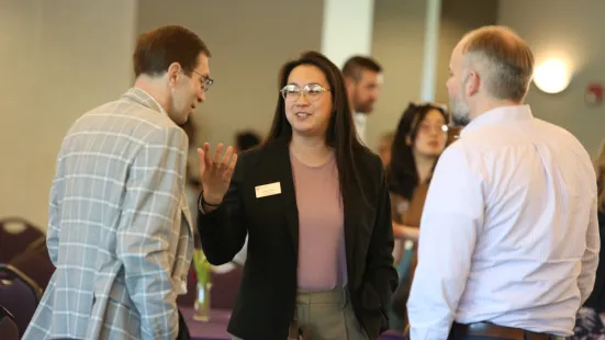 Three people converse during Faculty-Staff Institute