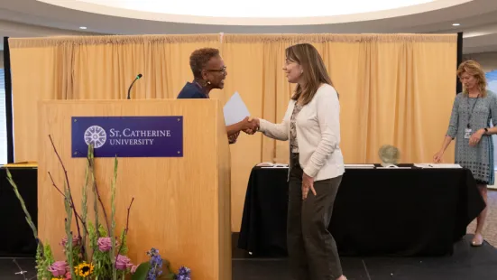 President Evans congratulates an awardee onstage