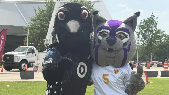 The MN United loon mascot poses with the St. Kate's wildcat mascot (Katie Cat). 