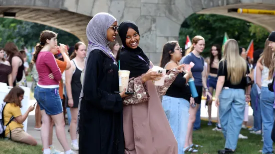 Two students smile on the lawn during Opening Celebration.