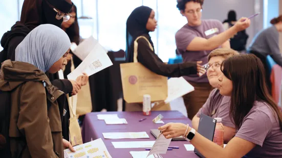 Students stop at a table during the career fair.