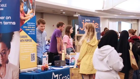 Students stop at a table during the career fair.