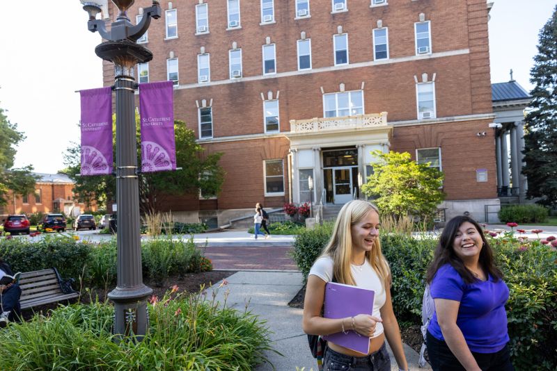 Students walk in front of Derham on the St. Catherine University campus