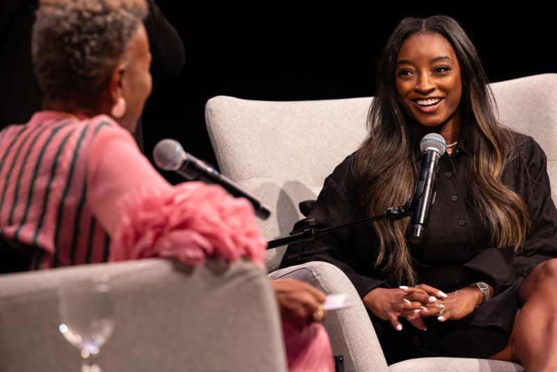 Simone Biles speaks on stage at The O'Shaughnessy.