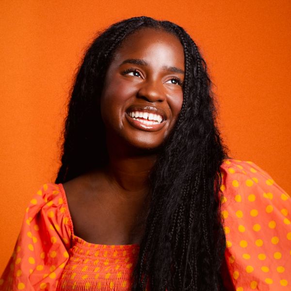 Headshot of Anna Gifty Opoku-Agyeman, a Ghanaian-American researcher, speaker, and author. She appears smiling, shoulders and head visible, facing forward.
