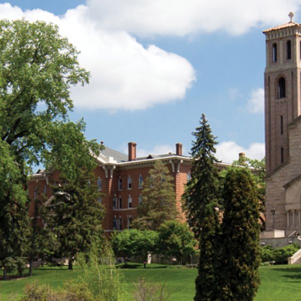 St. Catherine University campus with green trees, historic and modern buildings, and the Career Development Center logo