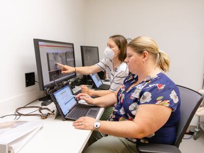Nursing educator working on computer with student