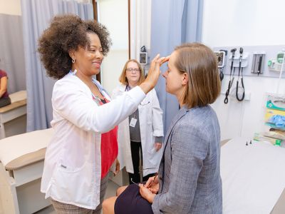 Nurse practitioner working with patient in clinic