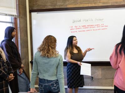 Group going over plan on a white board