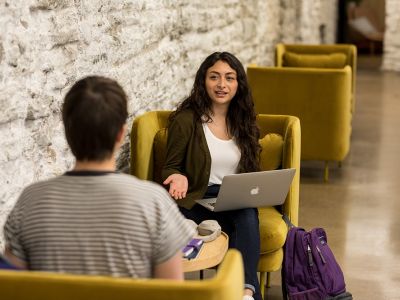 Communications student going over a project with another person
