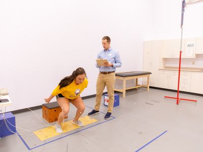 Female student doing physical tests with instructor