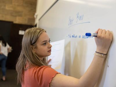 Student working on whiteboard in classroom