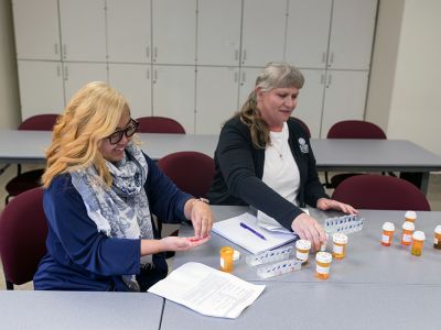 Student and Instructor organizing prescription pills