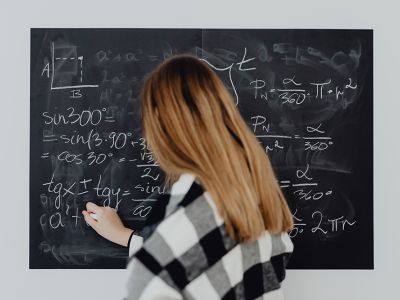 Woman doing math on chalkboard