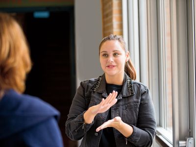 Woman signing to a deaf or hard-of-hearing individual