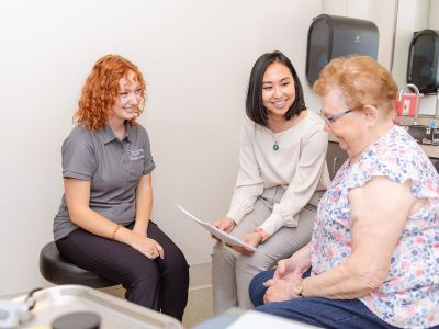 Nurse practitioner seeing older patient.