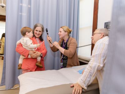 Pediatric nurses working with mother and child